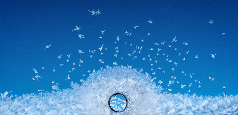 frost on an airplane window close up