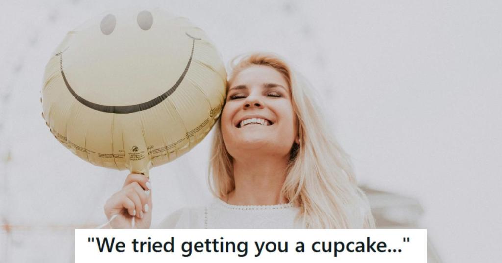Blonde woman smiling and happily holding a birthday balloon